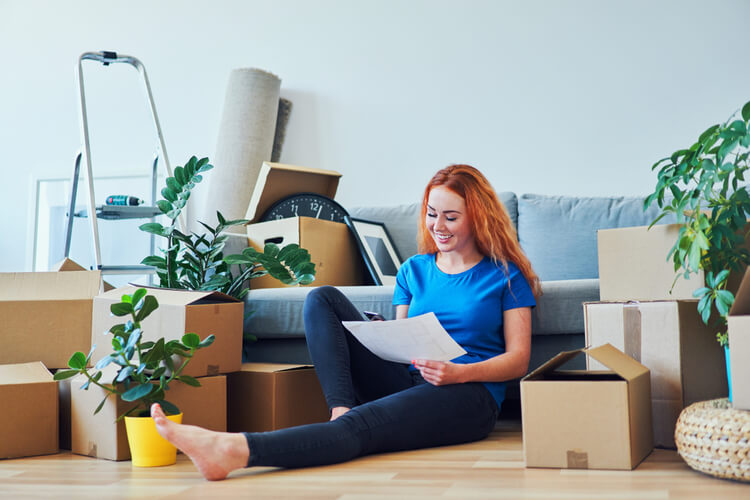 First-Time Apartment Renter? How to Make Sure Your Application Is Approved Young woman who just moved into a new apartment