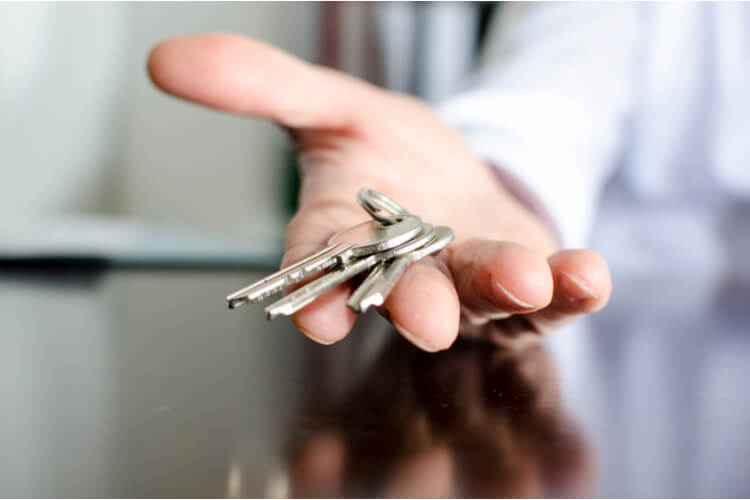 8 Rental Myths New Landlords Should Know hand closeup offering house keys