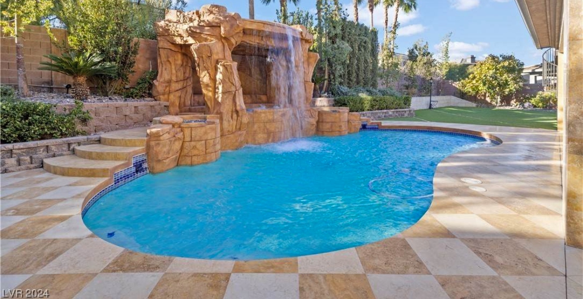 blue water in the large pool of a house for rent in las vegas