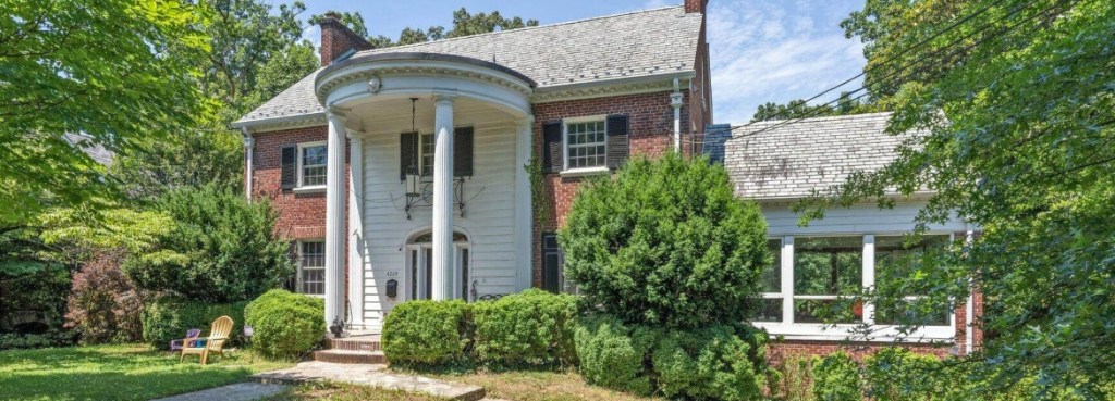outside of a house for rent in Washington DC with columns and lots of greenery
