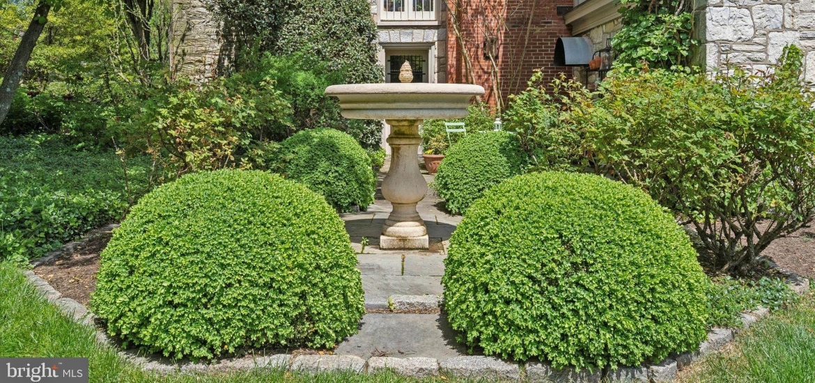 classical stone fountain outside a historical philadelphia house for rent