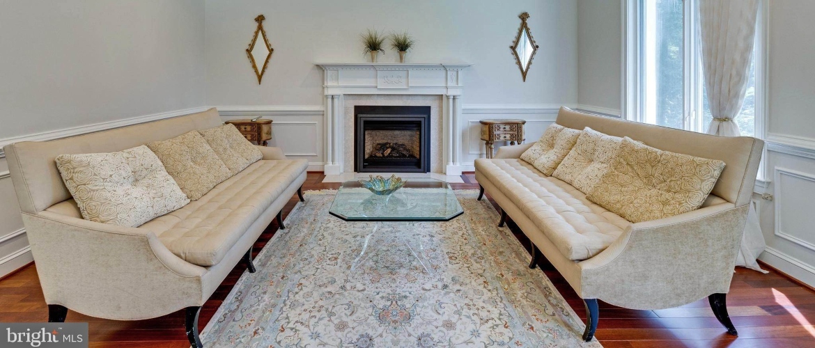 family room with comfy couches and a fireplace in a house for rent in Bethesda Maryland