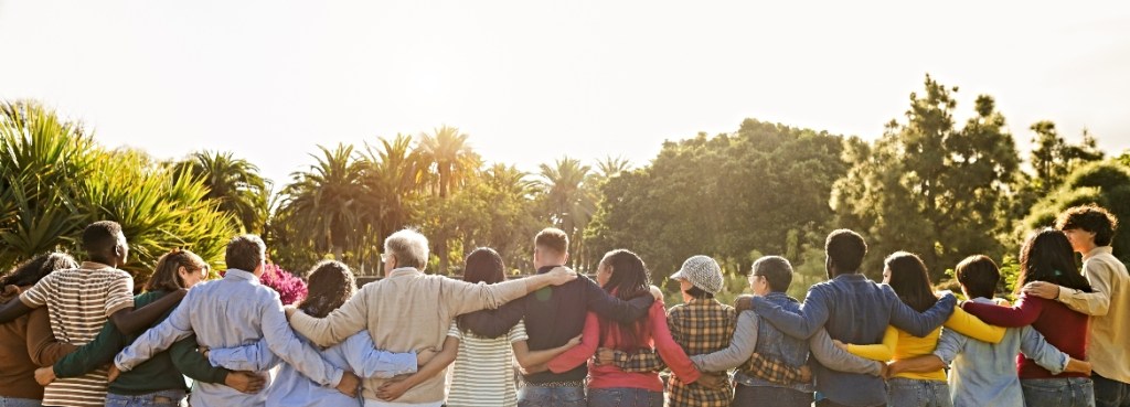 Renting & Community Connection: How House Renters Can Get Involved in Their Neighborhood Group of house renting neighbors hugging and collaborating on a community project