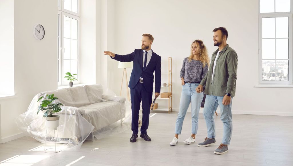 Real estate agent giving future house renters a tour about big new house rental