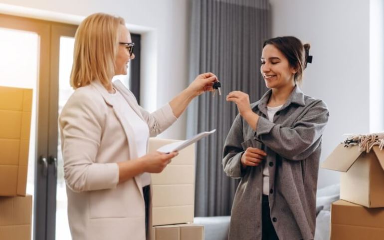 Landlord or property manager giving keys to happy renter, leasing new rental, accommodation tenancy 

