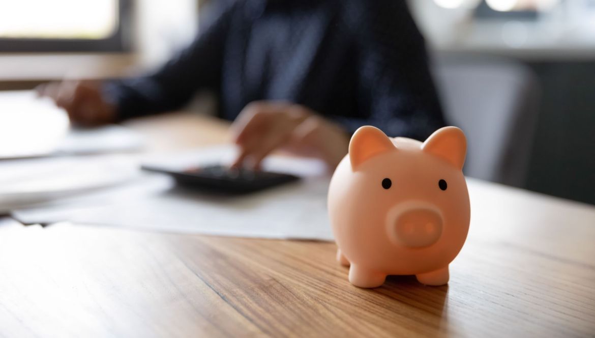 Security Deposits Explained: What to Expect & How to Protect Yours Close up of piggybank on wooden table of a renter thinking about security deposits