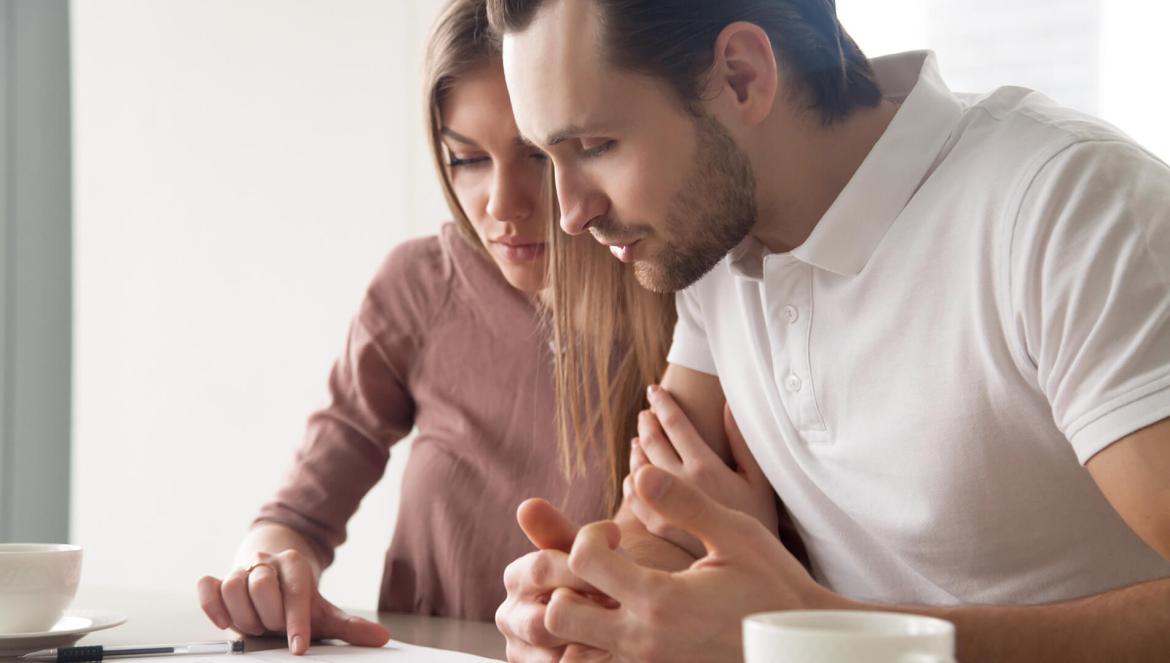 couple of house renters reading rental lease